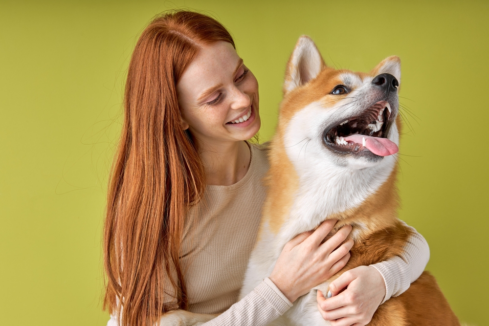 Happy,Red-haired,Lady,In,Casual,Wear,Hugging,Purebred,Pet,Dog,